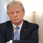 U.S. President Donald Trump with his arms crossed