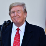 Donald Trump standing in front of a microphone