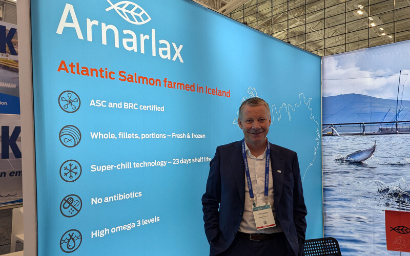 Arnarlax CEO Björn Hembre inside his booth at Seafood Expo North America