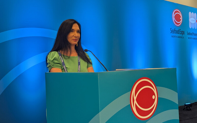Macro-economist, geopolitical finance expert, and best-selling author Nomi Prins at a podium at the 2025 Seafood Expo North America