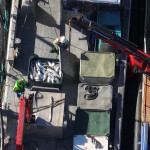An aerial view of workers on a salmon farm