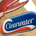 A sign featuring the Clearwater Seafoods logo hanging by chains from a lobster claw