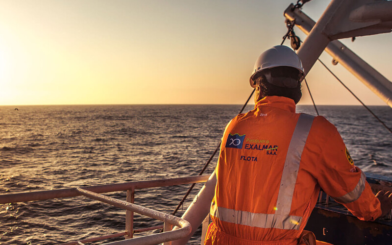An Exalmar employee on a boat staring out to the sea