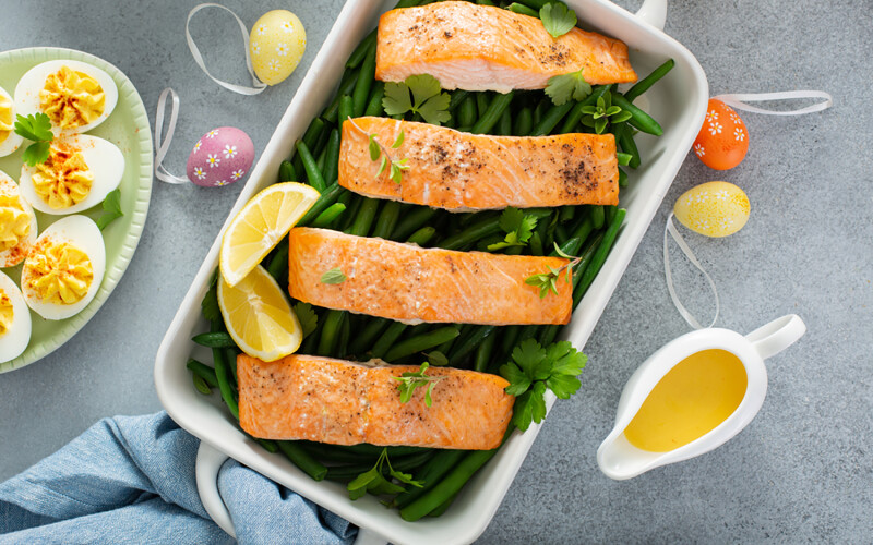 A salmon dish with Easter eggs surrounding it