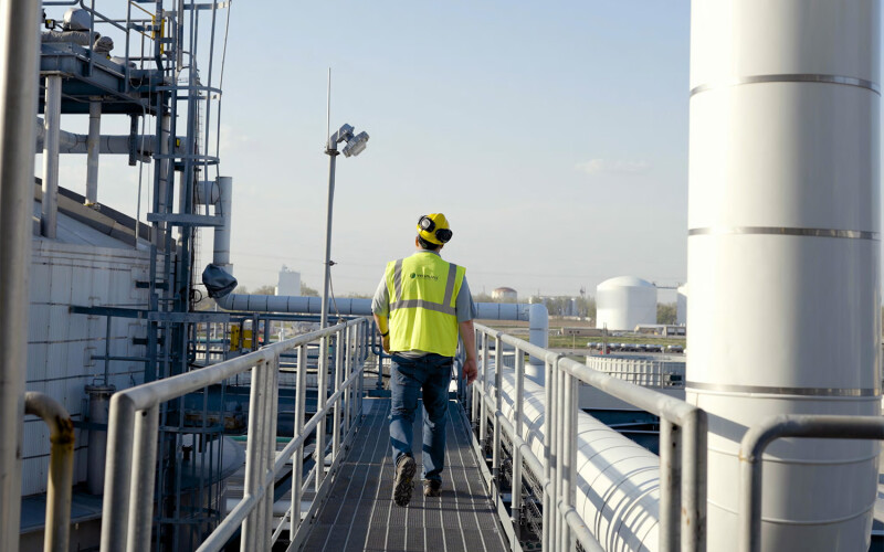 A Veramaris worker on a walkway at the company's manufacturing facility