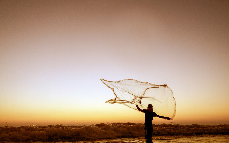 A fisherman throwing a net in Bangladesh