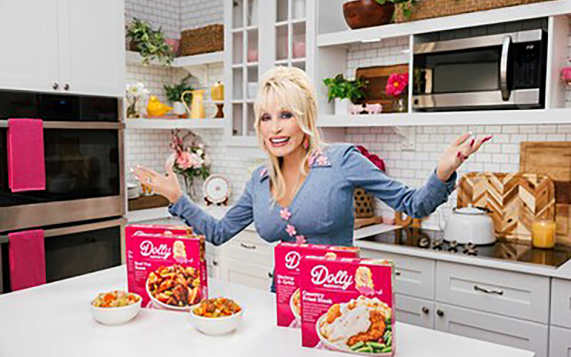 Dolly Parton posing with her new Conagra products