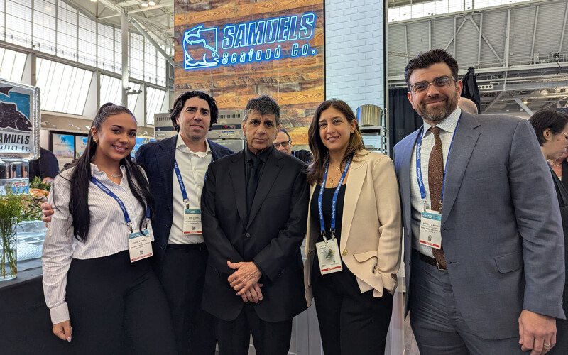Multiple generations of the D'Angelo family posing in the Samuels Seafood booth at the 2025 Seafood Expo North America