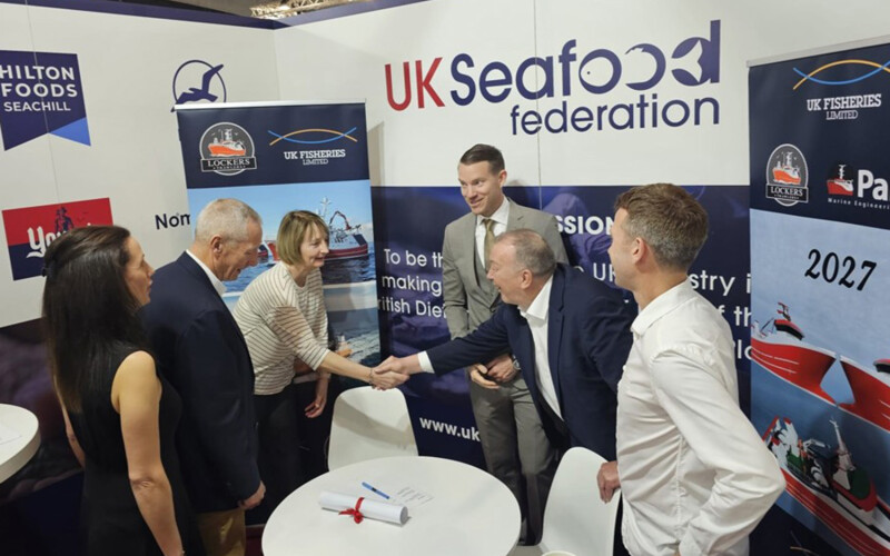 Representatives of UK Fisheries, Lockers Trawlers, and Parkol Marine Engineering shake hands