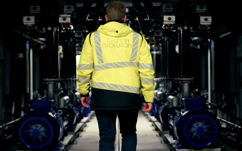 A Salmon Evolution employee walking through the company's facility