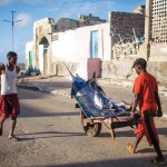 A Somalian man transporting fresh fish