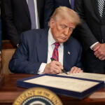 U.S. President Donald Trump signing an executive order