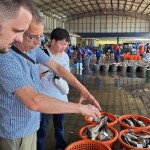 Dr. Timothy Wiese, Professor Dave Little, and Arnan Hirunratanakorn in a fish market in Thailand