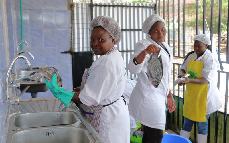 Camino Ruiz employees cleaning off fresh tilapia