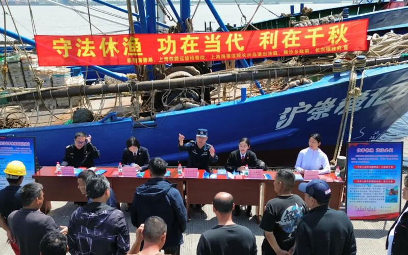 Chinese Coast Guard officials promoting the country's annual summer fishing moratorium