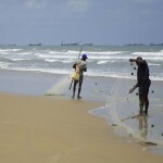Gabon fishermen hauling in nets on the shore