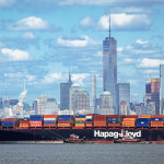 A shipping vessel with the skyline of New York City in the background