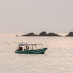A small boat in the water in Asia