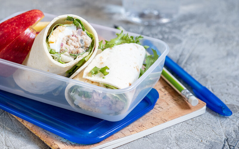 A school lunch featuring a tuna wrap