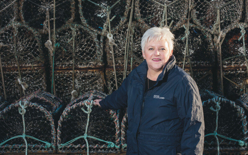 Seafood Scotland CEO Donna Fordyce in front of some lobster traps