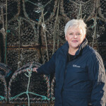 Seafood Scotland CEO Donna Fordyce in front of some lobster traps