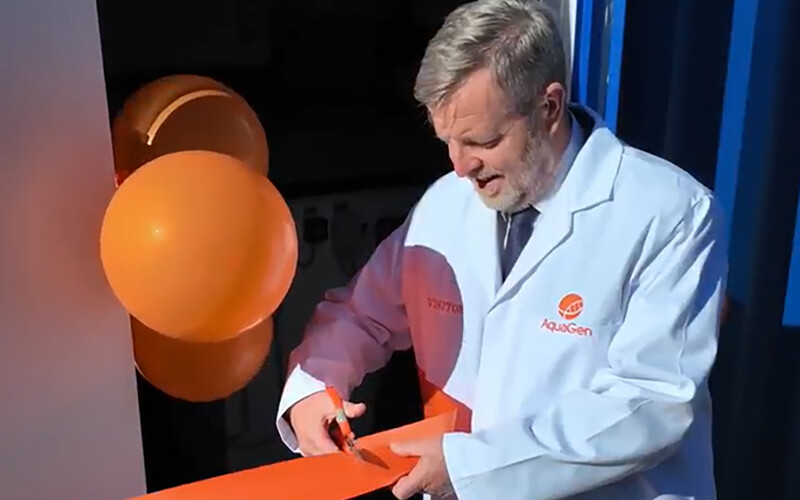 Finlay Carson cutting a ribbon