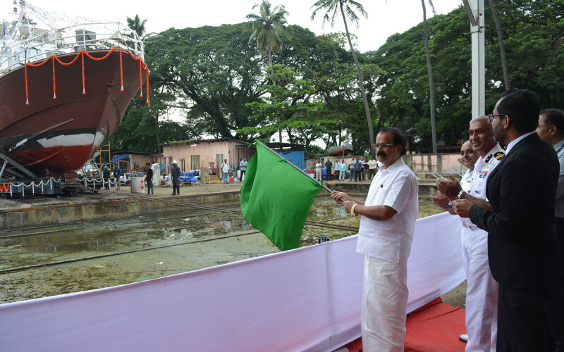India Union Minister of State for Fisheries George Kurian holding a green flag