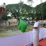India Union Minister of State for Fisheries George Kurian holding a green flag