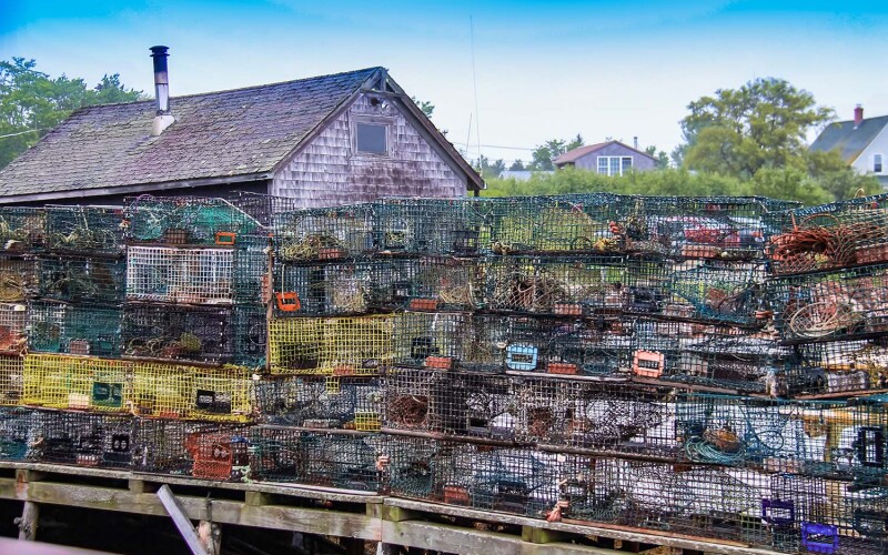 A pile of lobster traps on a dock in Maine