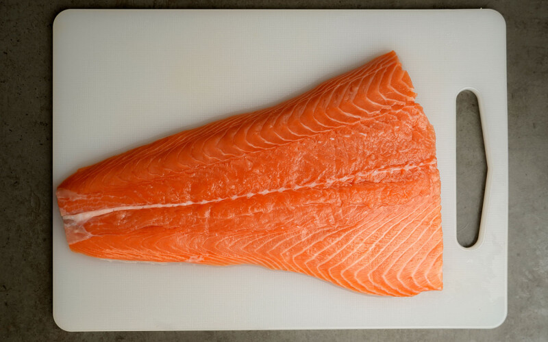 A fillet of salmon on a cutting board