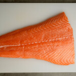 A fillet of salmon on a cutting board