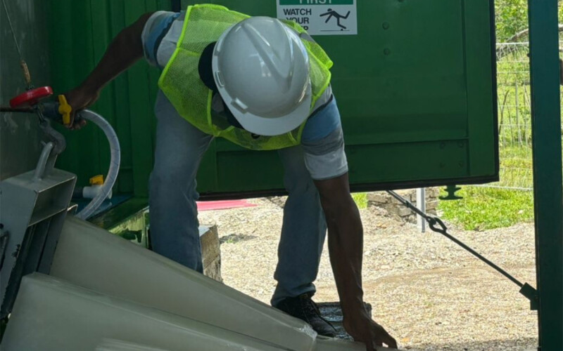 A worker operating the solar-powered ice maker in Kawa, Maluku, East Indonesia