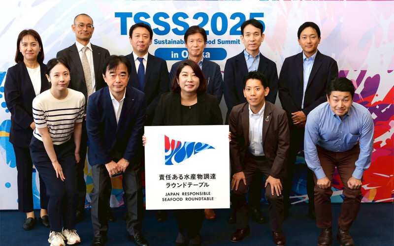 Representatives of Japanese seafood companies posing with the Japan Responsible Seafood Roundtable logo