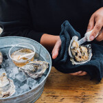 A woman shucking oysters