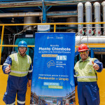 Workers posing in front of a promotional poster for the new project