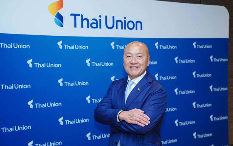 Thai Union CEO Thiraphong Chansiri in front of a banner