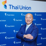 Thai Union CEO Thiraphong Chansiri in front of a banner