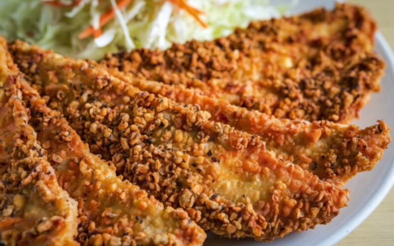 Breaded and fried catfish on a plate