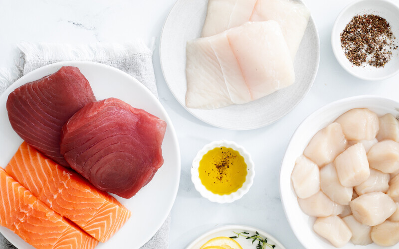 An array of Fulton Fish Market offerings, such as tuna, salmon, and scallops