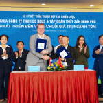 De Heus and Minh Phu representatives standing on stage in front of a banner