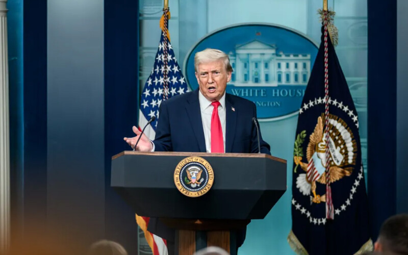 Donald Trump at a podium in the White House press room