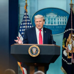 Donald Trump at a podium in the White House press room