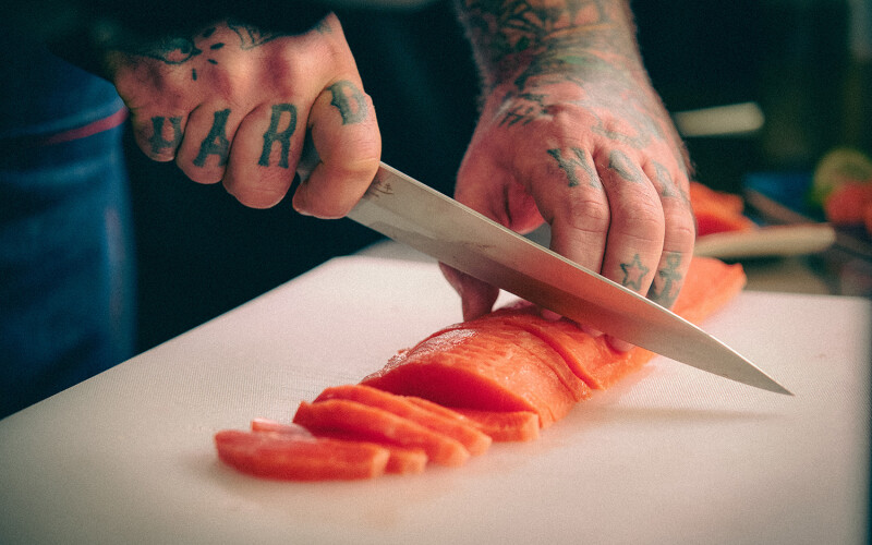 A chef cutting Caleta Bay trout