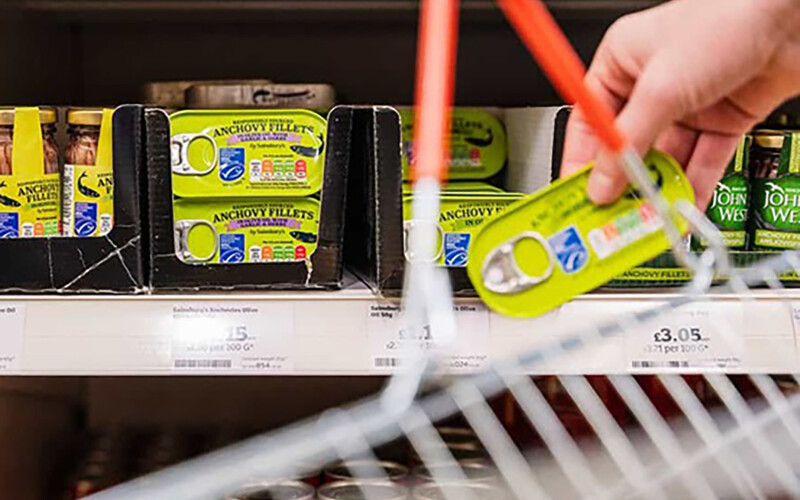 A shopper selecting MSC-certified anchovy