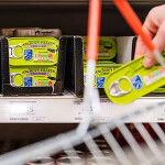 A shopper selecting MSC-certified anchovy