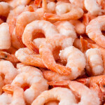 A pile of frozen cooked shrimp
