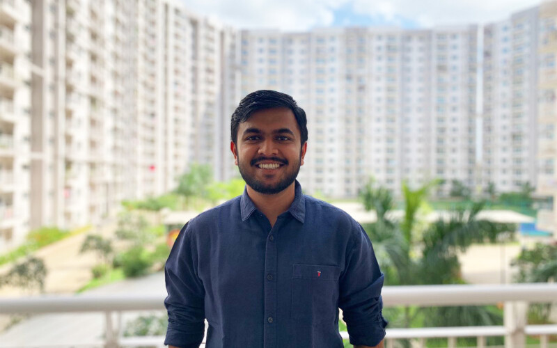 Ankit Alok Bagaria standing on a balcony with buildings in the background