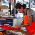 A person selling salmon