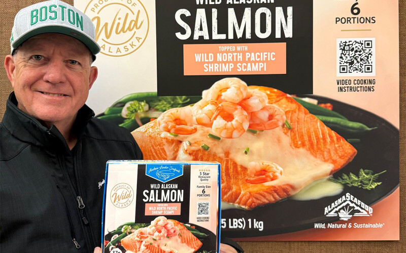 Keith Singleton holding up a box of the company's new salmon product