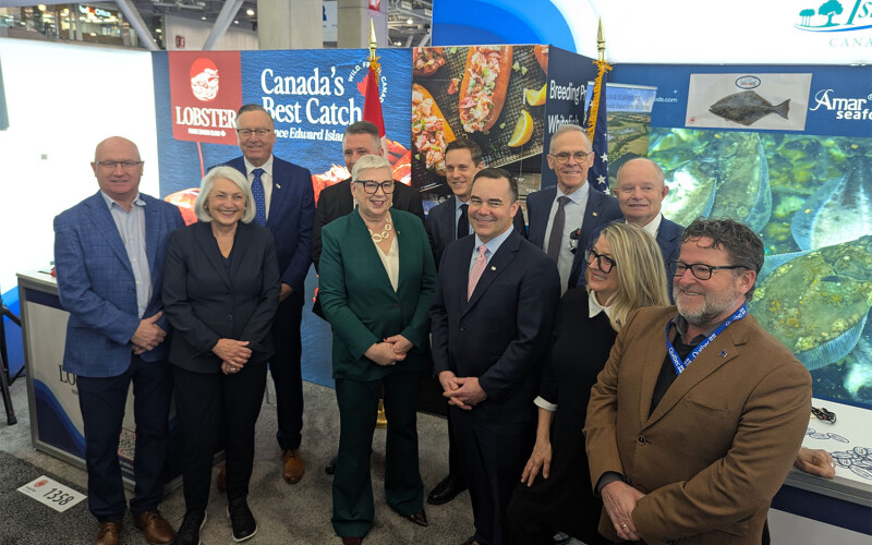 Canadian fisheries ministers pose in a booth at Seafood Expo North America